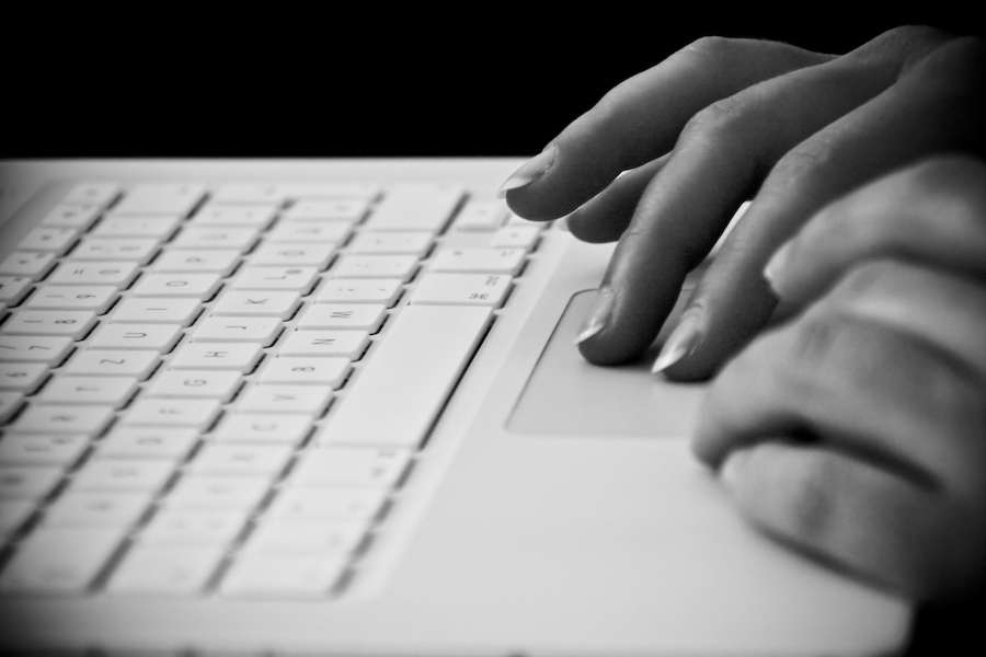 Blogger typing on laptop