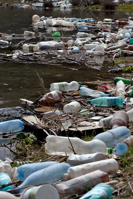 Plastic bottles and garbage on the bank of a river from Flickr via Wylio