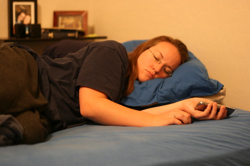 Girl sleeps with cell phone in her hand