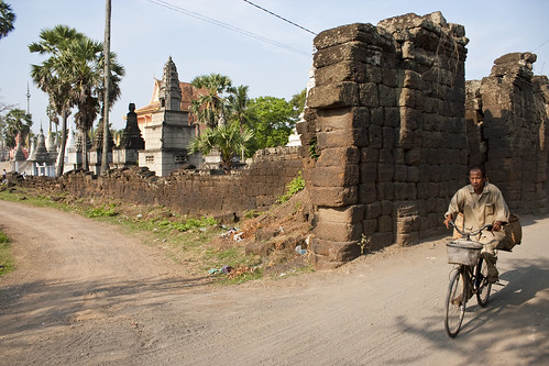 city man bike bicycle stone wall architecture religious temple town mixed ruins asia cambodia southeastasia cambodian khmer ride stupa buddhist graves sacred kh wat chedi oldnew mekongriver kampuchea inuse kampongcham watnokor kompongcham angkorbahjay