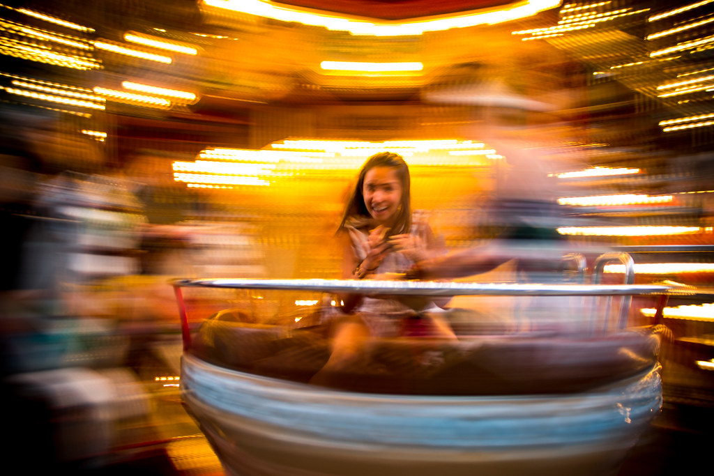 Girl enjoying the pleasure of speed on a carousel in Avignon, Southern France.
