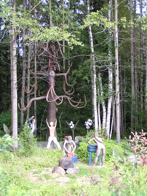 A concrete tree with more humanoid statues