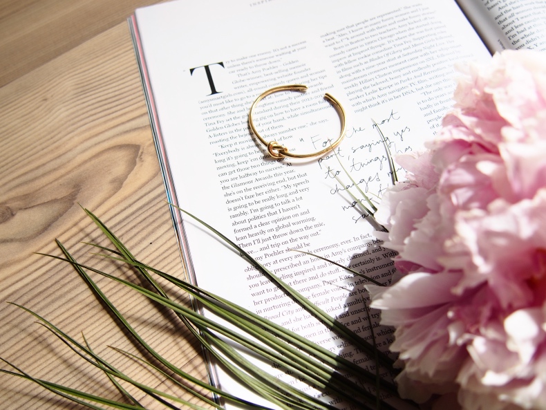 Pink peony, fashion magazine and golden knot bracelet