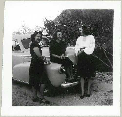 Three women in front of a car
