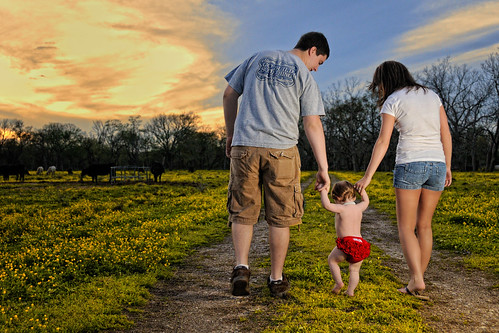 family flowers sunset portrait sky baby girl field clouds mom necklace couple dad texas child tx father mother oneyearold brazoria sb900 bluecityphotographycom