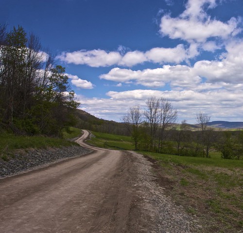 road blue trees sky clouds spring windy dirt gravel pennslyvania