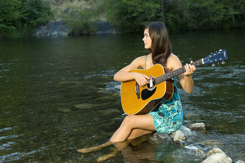 trees sunset portrait musician music woman playing love water girl beautiful beauty smile shirt female river relax person one model sitting guitar young romance teen sound instrument attractive teenager resting brunette relaxation talented acoustics