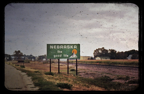 road sky film sign clouds landscape interesting scenery nebraska pavement traintracks stateline comeandgetit badfinger1969