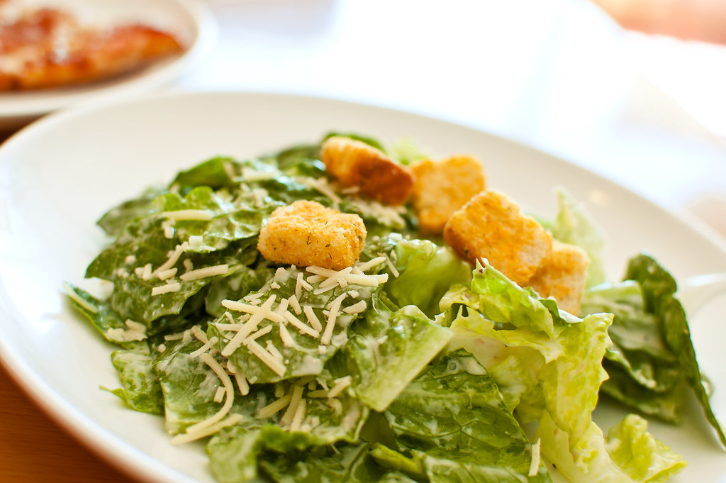 Caesar Salad in a white dish. It is not an Italian food