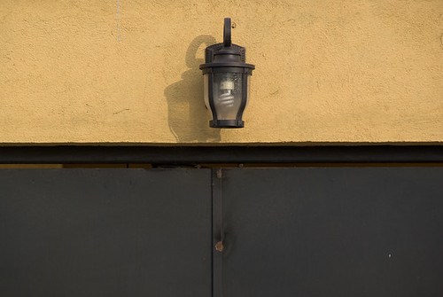 door shadow lamp yellow lightbulb metal wall mexico closed morelia center burn michoacan