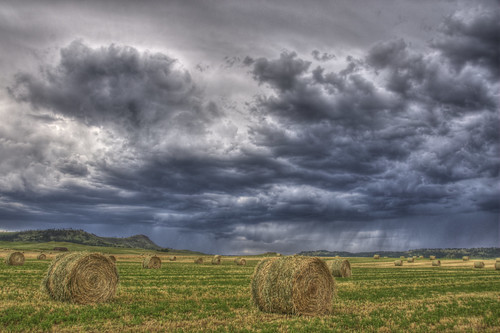 ranch sky storm grass clouds southdakota blackhills landscape farm round hay bale minnekata
