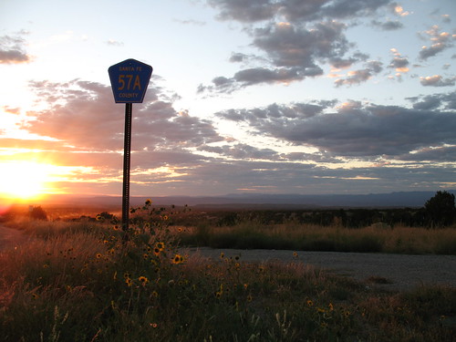 flowers sunset sky sun sunlight signs newmexico sign clouds landscape golden landscapes desert sunsets wildflowers nm highway14 turquoisetrail hwy14 57a santafecounty