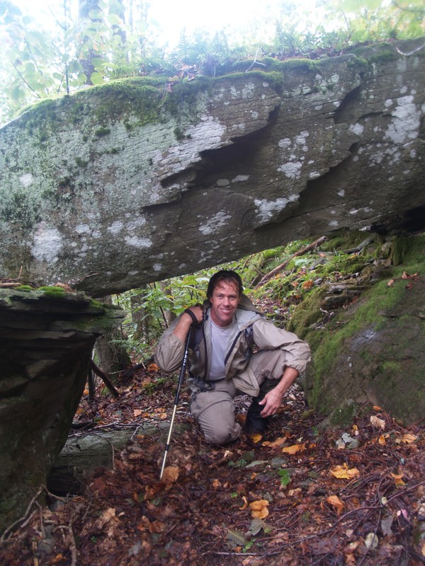 Paul finds a dry spot under a rocky roof
