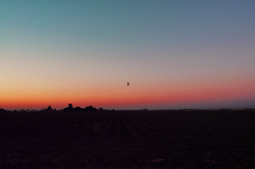 sunset airplane chemicals feild cropduster