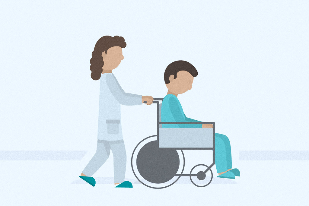 nurse pushing a patient in a wheelchair