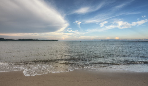 beach ocean sea water waves froth ripples sand horizon changibeach landscape clouds cloudy sky sunset daylight coast singapore southeast asia