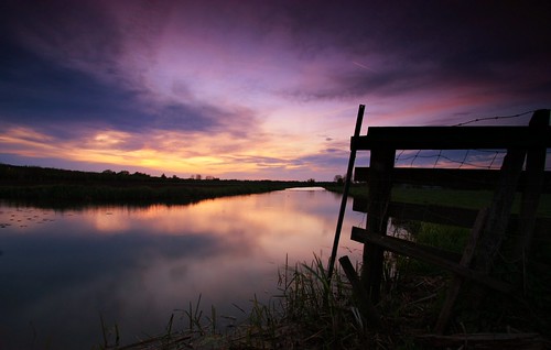 sunset dusk evening spring fence barbedwire sky reflections water canal polder netherlands dutch holland haarrijn outdoor