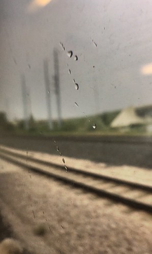 closeup macro wateronglass storm traintrack fromthetrain view track darkclouds rain water raindrop window train