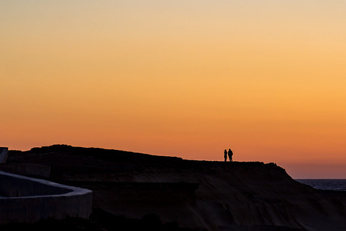 gozo għawdex malta xwejni couple orange rocks sea silhouette sky sunset watching