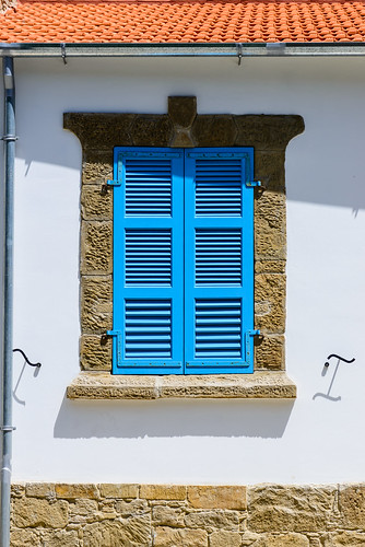 blue shutters tochni stone roof