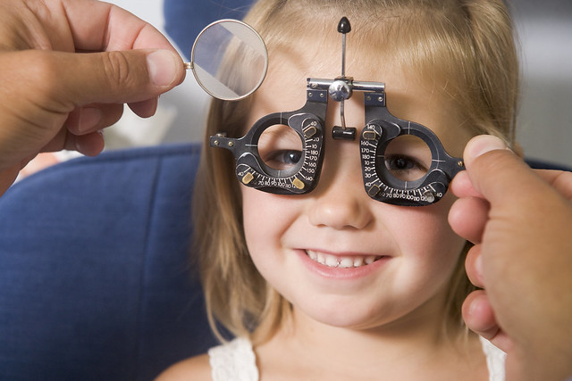 Girl having her eyesight tested by optometrist