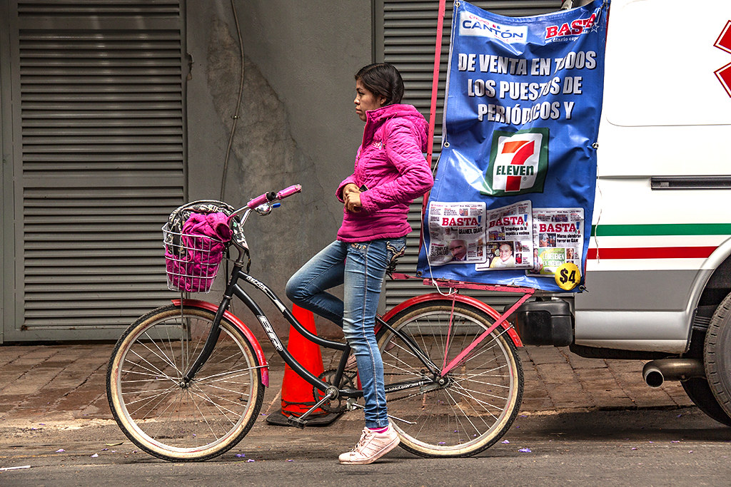 Woman on bike advertising Basta and 7-11--Mexico City
