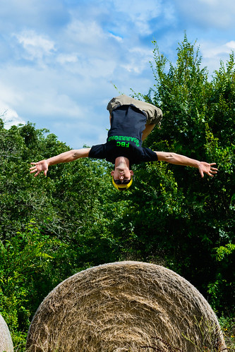 flying hay bale man gymnastics flip
