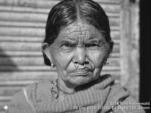 photo physiognomy psychological primelens street portrait closeup monochrome cultural character frowning nose nosepiercing wrinkles bareheaded blanket consent respect female posing authentic softfocus eyes adivasi matthahnewaldphotography face facingtheworld blackandwhite horizontal head india jeypore woman nikond3100 nosejewelry old orissa outdoor nosering market 50mm oneperson livedinface expression headshot nikkorafs50mmf18g fullfaceview 4x3ratio 1200x900pixels resized lookingatcamera