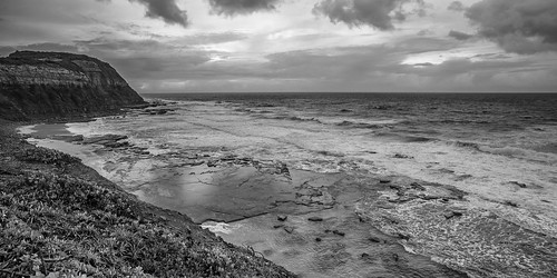 pentax k1 smcpentaxa20mmf28 landscape seascape sea waves shoreline rocks cliffs threatening stormy sky clouds reflections monochrome blackandwhite susangilmore newcastle australia