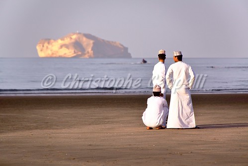 oman muscat omani men taqiyah dishdasha traditionaldress white beach sea gulfofoman sunset middleeast arab