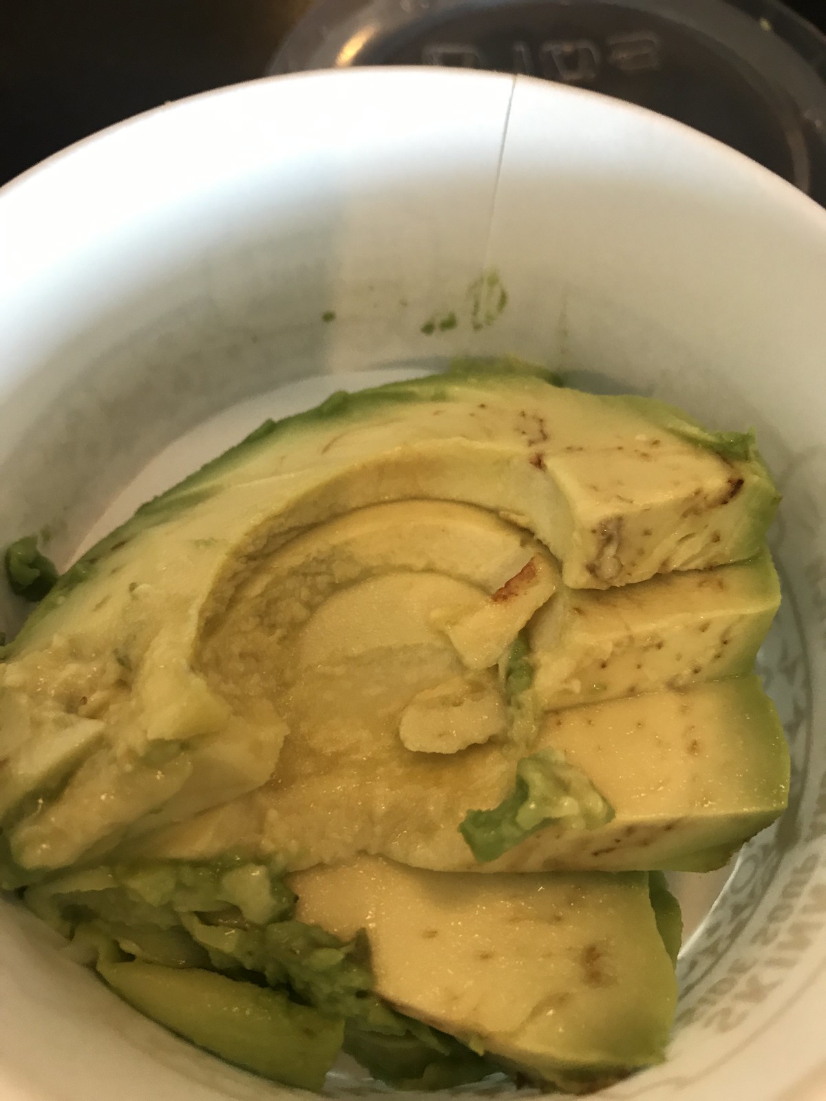 Rent or Avocado? Avocado of course! - Image of sliced avocado in a white bowl