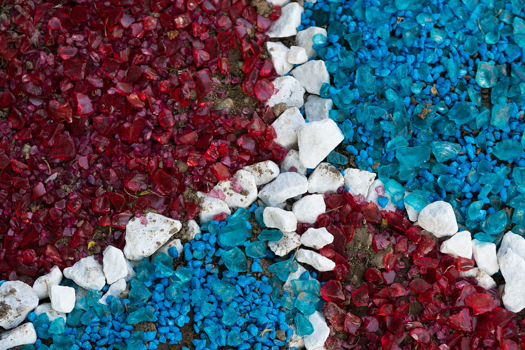 A close-up view of a peace sign made of colored rocks in a driveway in the Irvington neighborhood of Portland, Oregon