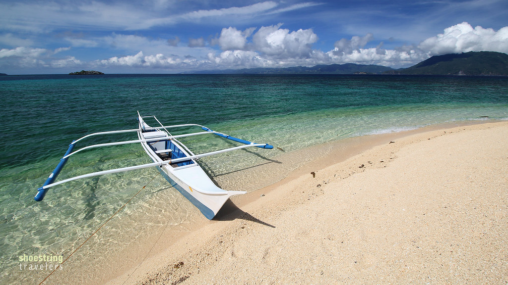 a fishing boat on one of Cobrador Island's immaculate white sand beaches