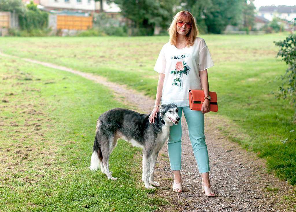 Soft whites and pastels summer outfit: Rose print sheer layered top mint trousers chinos pants nude crossover mules orange tinted aviators coral clutch | Not Dressed As Lamb, over 40 style