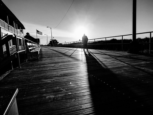 boardwalk sunrise walker bwwednesday incidentalpeople morningsky oceancity nj blackwhite