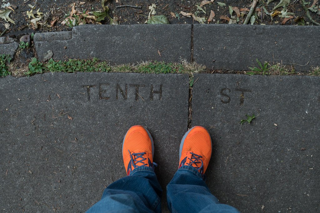 Letters in the sidewalk use the original name for 10th Ave, Tenth Street