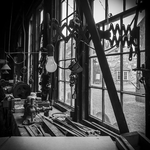 nikon d90 amateur handheld summer june 2017 eastbroadtop eastbroadtoprailroad ebt rail railroad heritage historic antique relic abandoned neglected rusty crusty rust crust dirty orbisonia pa pennsylvania rockhill rockhillfurnace train trains bw blackwhite blackandwhite desaturated buildings interior inside vignette tokina 1116mm workbench lamp light tools window outside
