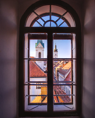 city window frame glass view light shadows church tower zagreb croatia
