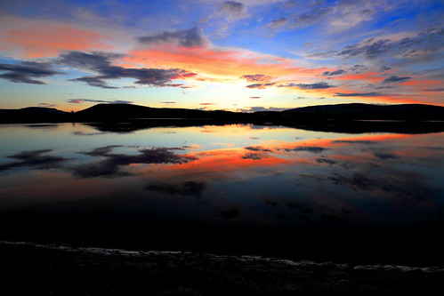 reflections landscape sunlight sunset clouds lintrathen loch scotland scottishwater lake water dusk reds orange bluesky still calm tranquil flat hills