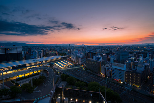 osaka japan skyline city cityscape sunrise twilight summer building mountain train modern