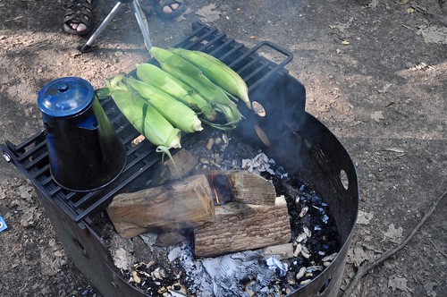 Cooking corn over the campfire