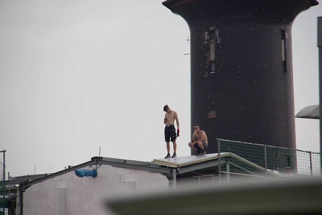 Two Construction Workers standing on top of a roof at Berlin Ostkreuz