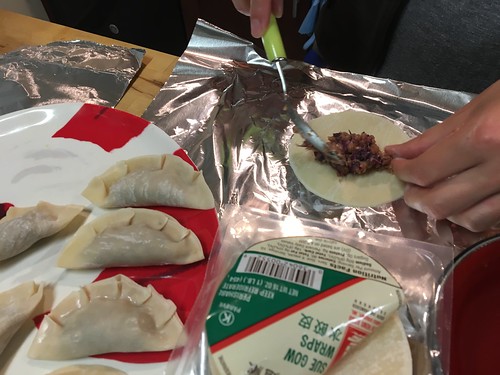 Spooning filling into dumplings