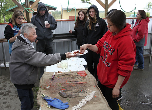 Mary Lou Bottorff offers smoked salmon to Julianne Wilson and other participants to sample at the end of the workshop.