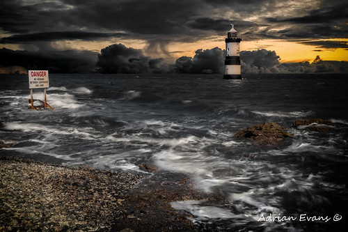 puffinisland lighthouse danger trwyndu sunset penmon blackpoint water dangersign landmark outdoor clouds storm stones sea rocks wales british coastline sky penmonpoint uk trwyndulighthouse northwales boat pebbles seascape sign coast anglesey waves bythesea