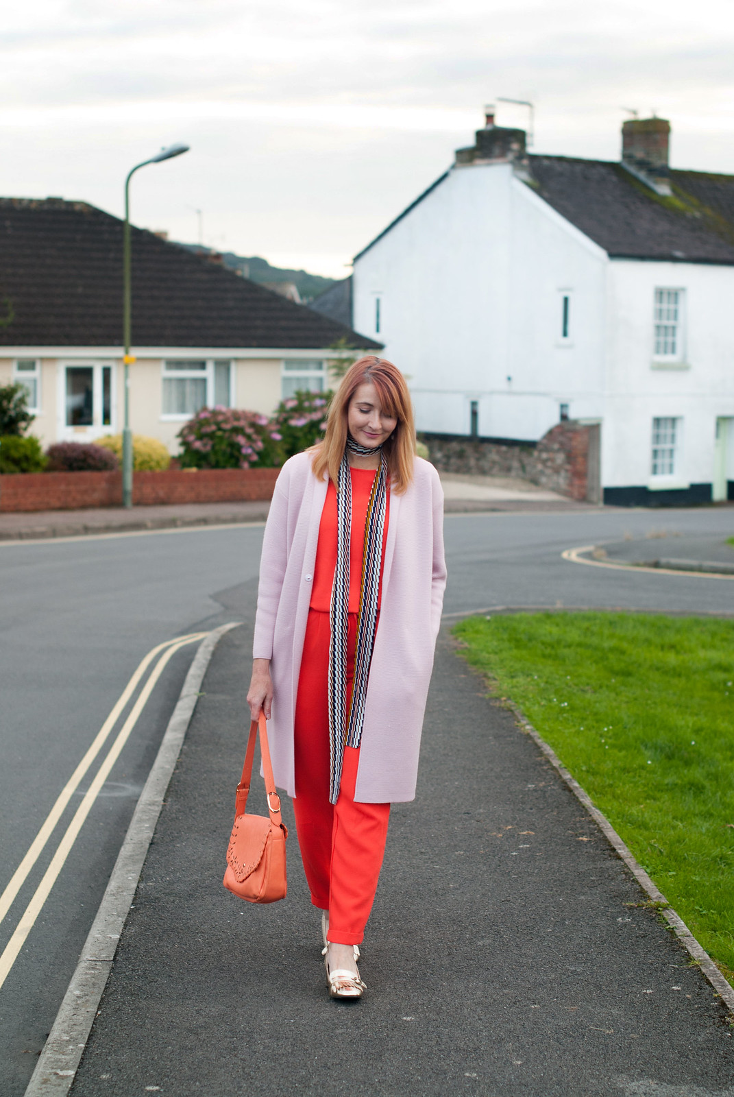 Ways to wear an orange jumpsuit: With a longline pink coatigan, metallic gold block heel loafers, 70s style skinny scarf | Not Dressed As Lamb, over 40 style