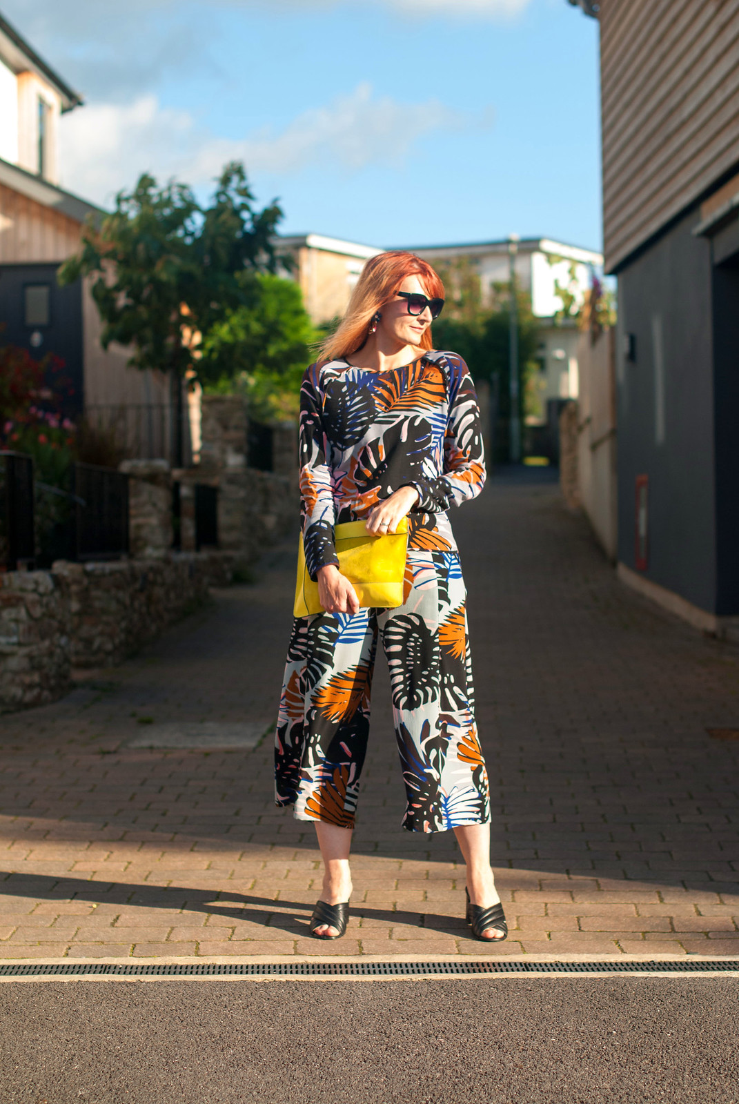 Palm print co-ords: Long sleeve top and wide leg crop trousers culottes pants yellow suede clutch bag black crossover block heel mule sandals statement oversized earrings cat eye sunglasses | Not Dressed As Lamb, over 40 style