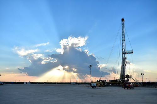 pioneer oilandgas oilfield texas midland permianbasin texasten pullingunit rig storm westtexas sunset landscape sunrays clouds sky