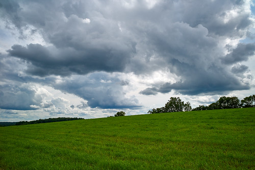 clouds landscape sky field grass dramatic hayfield