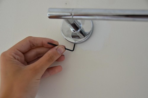 9. Use supplied hex key to secure towel rod to bracket